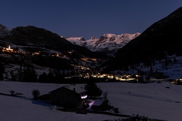 Champoluc and Antagnod viewed in the night with lights and mountains in the background, Aosta Valley, Italy