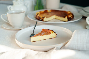 Beautiful served slice of fresh baked basque cheesecake on a table, healthy baked food
