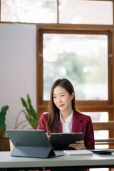 Business documents on office desk with laptop and smart phone and graph business diagram and woman working at office.