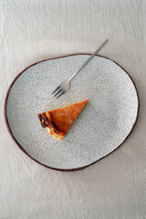 Top view of fresh baked Cheesecake san sebastian on a minimalist plate