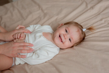 baby girl is lying on her back at home on the bed in the bedroom ,top view