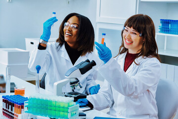 Two female doctors working in laboratory, smiling