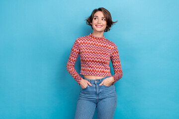 Photo of cute sweet lady wear pink shirt arms hands pockets looking empty space isolated blue color background