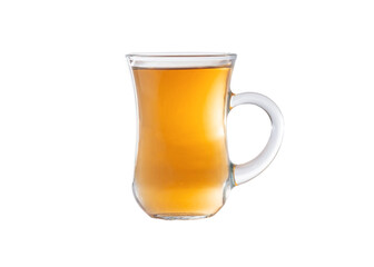 Amber color tea in a transparent glass cup. Cup isolated on a white background.