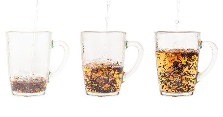 Adding hot water to a transparent cup with black tea leaves. Darjeeling tea. Shooted in motion. On a white background