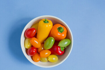 Bowl with small tomatoes and pepper