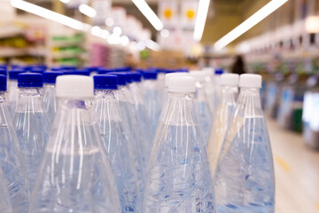 water bottles with blue caps in supermarket