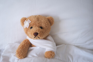 bear with bandage, child medical care . injured child teddy bear and painful in hospital, fell ill in the bed, accident, insurance, health care, risk, loss, emergency, protection, treat, kid , baby.