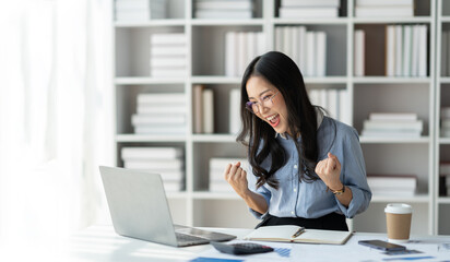 Fototapeta na wymiar copy space, panorama ,banner Modern working lifestyle, asian businesswoman showing happy gesture of online business success on laptop and mobile phone using internet happily in office.