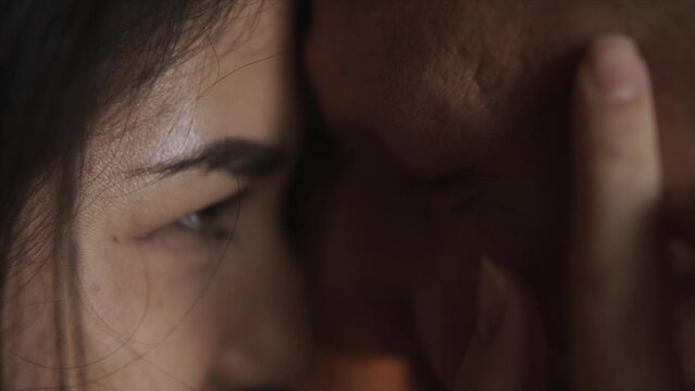 Girl stroking the face of her guy. Couple is looking at each other. Man and woman enjoy the tenderness of touch. Care and calm in the eyes of people in love, when they look at their soul mate.