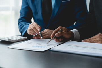 Group of business people meeting about business plans Present and analyze, discuss charts, financial graphs Growth of partners from documents and data on laptop computer at office.