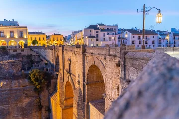 Papier Peint photo Ronda Pont Neuf Puente Nuevo in Ronda, in the province of Malaga, overlooking the gorge and hanging houses during a sunny summer day