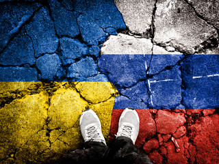 Flags of the Ukrainian and Russian flags were repeatedly exposed in cracks in the concrete floor. Ukraine and Russia. Double exposure of Ukraine-Russia war conceptual image.