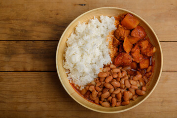Dish with beans, white rice and meat stew with potatoes. Typical Latin American food.