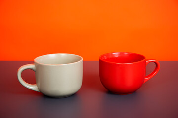 Mug of fragrant drink on an orange background.