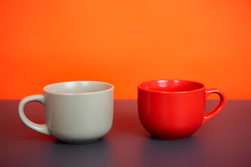 Mug of fragrant drink on an orange background.