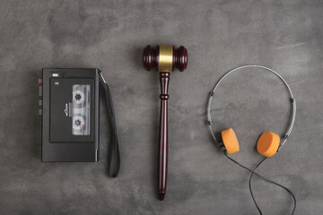 Music piracy and copyright protection law concept, gavel, tape recorder and headphones on table