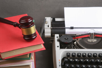 Writers desk - typewriter, books and judge's gavel, copyright protection law concept