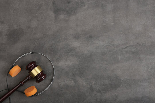Music piracy and copyright protection law concept, gavel, tape recorder and headphones on table