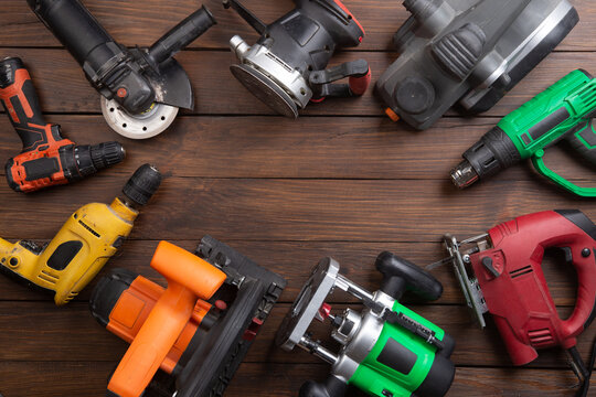 Set of electric tools on the wooden table. Various power tools for renovation and construction