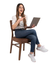 Naklejka premium Woman pointing finger, excited caucasian lady holding laptop woman pointing finger. Sitting chair over isolated transparent png image, copy space. Recommending website, studio shot. Happy young girl.