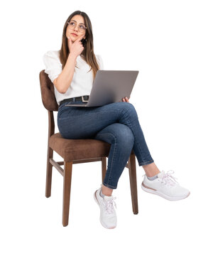 Thinking woman, young businesswoman sitting chair holding laptop, working and thinking woman. Isolated transparent png, lady touching her face looking aside copy space. Young girl using computer.