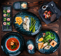 Lunch Thai soup Tom yum, sushi roll set, green salad, fish fillet in sauce with french fries and dessert.