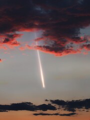Fototapeta na wymiar Meteor in the daytime sky. Daylight fireball in the Earth's atmosphere. Glow of a meteorite lights up the sky at sunset. 
