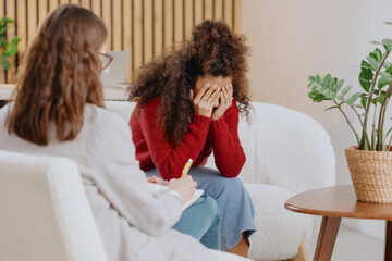 African American woman at psychotherapist's appointment, moral support, solving problems in relationship, tells psychologist about feelings and experiences. mental health and intelligence. depression