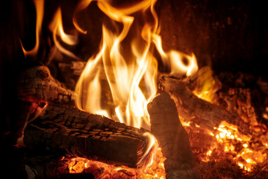 Close-up photo of fire in a fireplace. Burning wood logs.