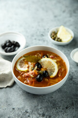 Traditional homemade soup with sausage and capers