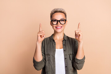 Photo of product manager content maker young woman wear glasses stylish shirt point fingers look novelty isolated on beige color background