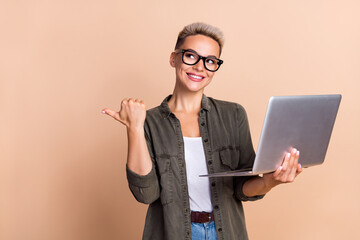 Photo of young thinking business hr manager woman short hairdo point finger hold laptop empty space...
