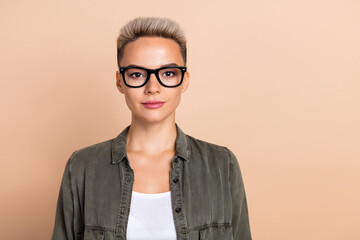 Photo of focused concentrated intelligent person calm face empty space ad isolated on beige color background