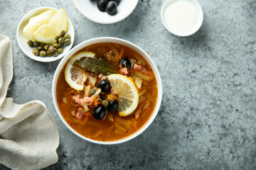 Traditional homemade soup with sausage and capers