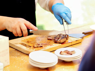 Man professional chef cooking meal outdoor