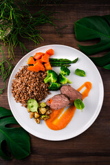 Healthy food beef fillet with buckwheat, broccoli, asparagus, zucchini, carrots and spinach.