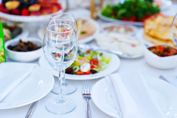 Two empty glasses on the table served for the holiday.
