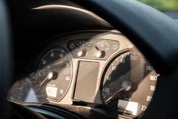 Selective blur on an analog car dashboard with the instrument panel, such as the RPM indicator, the...