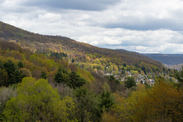 Town of Bradford Pa mountain valley landscape blooming season sky overcast theme USA town , Blooming trees, historic town.