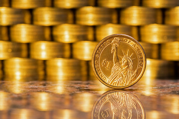 Coin in denomination of 1 american dollar on the background of gold coins - obrazy, fototapety, plakaty