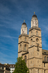 Fototapeta na wymiar Twin bell towers of Grossmunster church in Zurich city Switzerland, Wide-angle view, blue sky, no people