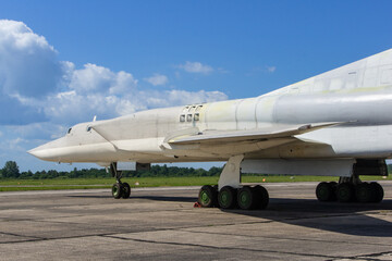 Fototapeta na wymiar Tu-22M3 (NATO - Backfire) aircraft, missile-carrying bomber, stands at starting position. Preparations for celebration of 100th anniversary of Russian Air Force. VillageTown, Russia, June 18, 2012