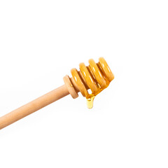 Honey dripping from dipper wooden honey stick isolated white background