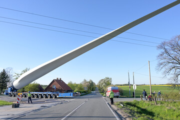 Heavy duty transport of a windmill blade lifted up to avoid obstacles such as a power lines on a...