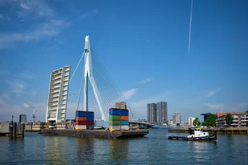Fototapete Erasmusbrücke Tug boat towing barge with containers under open bascule part of Erasmusbrug bridge in Nieuwe Maas river. Rotterdam, Netherlands