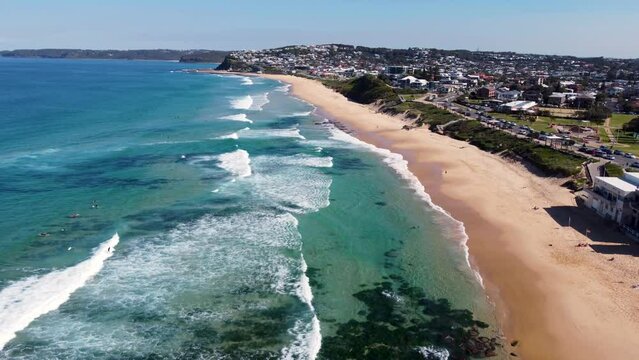 Aerial drone landscape view pan of Merewether Beach surfing clear ocean sea beach travel tourism Newcastle NSW Australia coastline 4K