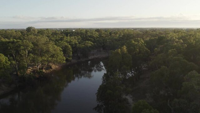 Revealing shot of river Murray at sunset on calm afternoon. 