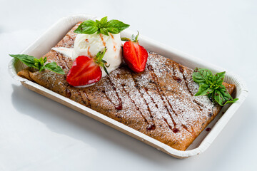 Fried sweet thin pancakes with cottage cheese, ice cream, fresh strawberry and basil.