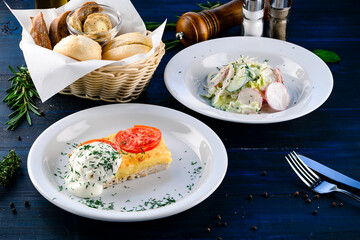 Chicken casserole with cheese and tomatoes with salad of cabbage, radishes, cucumbers and lettuce.